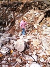 A girl walking on rocks